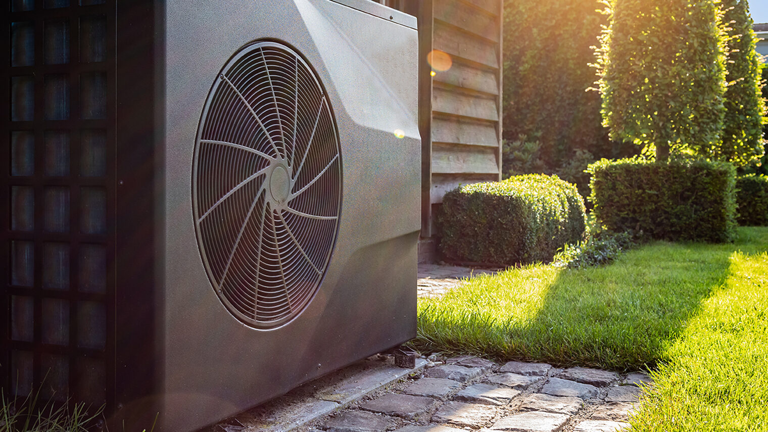 heat pump in front of pool house and green garden