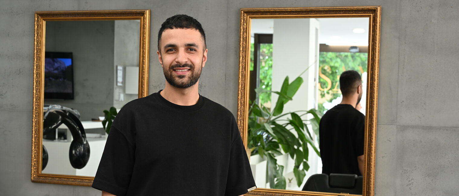 Hossam Alhorani Friseurmeister in einem Salon schaut in Kamera